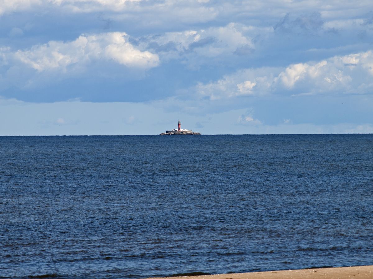 Kolka Lighthouse standing offshore where the Baltic Sea meets the Gulf of Riga